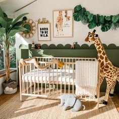 a giraffe standing next to a baby crib