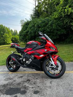 a red and black motorcycle parked in a parking lot