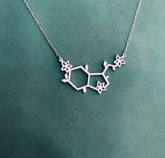 "Serotonin Necklace, Chemistry Necklace for Women. Serotonin is the chemical that produces happiness. This necklace is a great message that you literally create your own happiness and nobody else does. ✅ PRODUCT DETAILS * Material: solid sterling silver. * Pendant is 1.3mm thick. * The total length is the chain length only, it does not include the length of the charm. * All necklaces come with a 2\" extender for adjustable length. ✅ PRODUCTION & SHIPPING INFO 📌 Important: please be aware th Medicine Necklace, Science Necklace, Molecule Jewelry, Chemistry Necklace, Serotonin Necklace, Create Your Own Happiness, Chemistry Jewelry, Serotonin Molecule, Chemistry Gifts