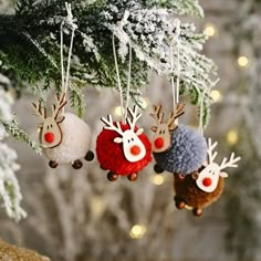 three christmas ornaments hanging from a tree