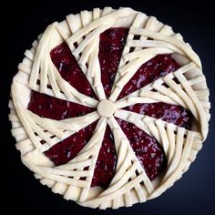 a pie with several slices cut out of it on a black surface, top view