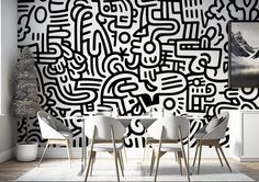 a black and white abstract wallpaper design in a living room with four chairs around it