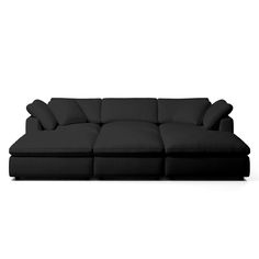 a black couch sitting on top of a white floor