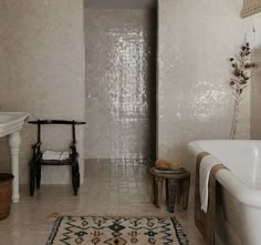 a bath room with a tub and a rug