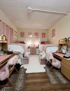 a bedroom with two beds, desks and shelves filled with personal items on top of them