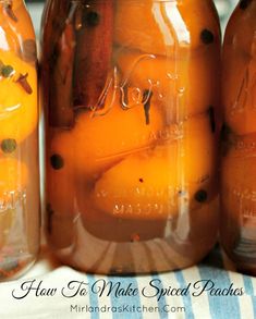 three jars filled with oranges sitting on top of a table