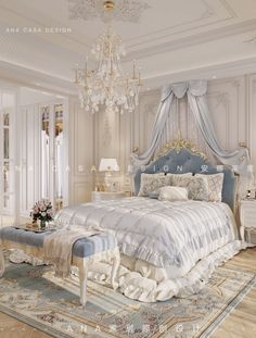 a large white bed sitting in a bedroom next to a chandelier and table