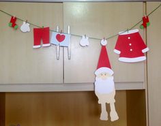 christmas decorations hanging from clothes line with santa clause