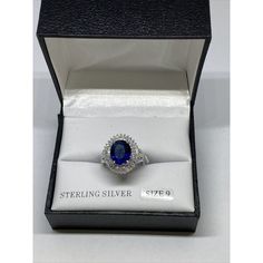 a blue and white diamond ring in a black box