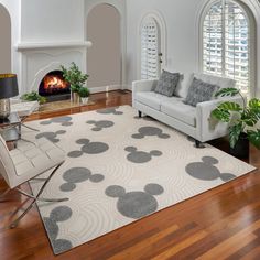 a living room filled with furniture and a fire place in the middle of a room