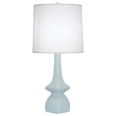 a light blue table lamp with a white shade on the top and bottom part of it