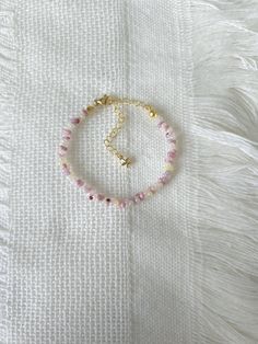 FOR OTHER DAINTY BEADED BRACELETS: https://www.etsy.com/ca/shop/ArtiChouXCanada?ref=seller-platform-mcnav§ion_id=46088511 Bracelet Length: 13-18cm (5.1-7 inches) with a 14k gold filled extender. This bracelet features an array of pastel colors: cream, white, and different shades of pink Japanese seed beads.   Thread may be visible since it is a handmade product   SIZING  Wrap a soft measuring tape snugly around the widest part of your wrist. Add 1.27cm (0.5in) to that measurement to determine the right bracelet size.  MATERIALS  - Japanese MGB glass seed beads(2x4mm) - 14K gold filled extender  CARE INSTRUCTIONS   To maintain its radiance, gently clean the bracelet with a soft cloth and store it in a jewelry box or pouch when not in use.   SHIPPING INFORMATION  Canada: Standard Shipping (F Adjustable Pastel Beaded Bracelets, Dainty Beaded Charm Bracelet With Round Beads, Dainty Adjustable Crystal Bracelet With Round Beads, Adjustable Pink Rosary Bracelet With Faceted Beads, Dainty Adjustable Pearl Bracelet With Faceted Beads, Adjustable Dainty Pearl Bracelet With Faceted Beads, Dainty Pink Bracelets With Faceted Beads, Dainty Pink Beaded Bracelets With Gemstone Beads, Dainty Handmade Crystal Bracelet With Round Beads