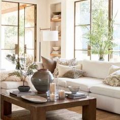 a living room filled with furniture and lots of windows