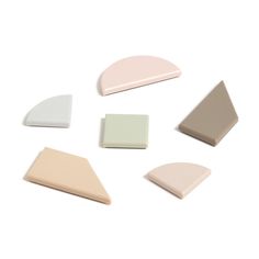 four different shapes of white, beige and light pink ceramic tiles on a white background