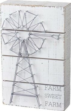 a white wooden box with an old fashioned ferris wheel on it's side and the words farm sweet farm