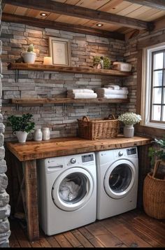 a washer and dryer in a small room with shelves above the washer