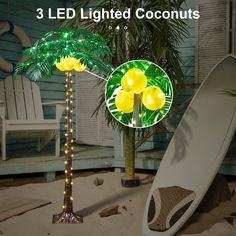 three lighted coconut trees next to a white surfboard and palm tree with yellow lights