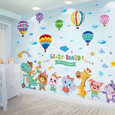 a child's room with colorful wall decals and balloons in the sky above it