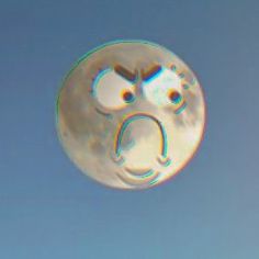 a soap bubble in the shape of a smiley face on a clear blue sky background