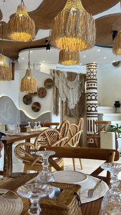 a restaurant with wicker chairs and chandeliers hanging from the ceiling