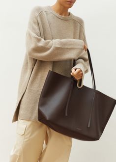 Color: Coffee Bean Pebbled leather Oversized design Thin top handles Open top Interior pocket Front embossed logo 100% Cow leather By Malene Birger. Imported Brown Leather Tote Bag, Paris Store, Denim Suit, Frankie Shop, Brown Leather Totes, Paris Woman, Color Coffee, Malene Birger, By Malene Birger