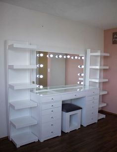 a white dressing table with lights on it and a stool in front of the mirror