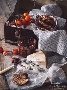 some food is laying out on the table with tomatoes and other things to eat in it