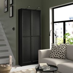 a living room filled with furniture next to a stair case