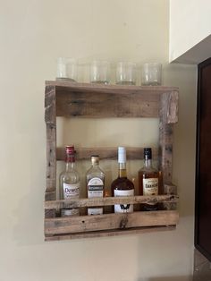 a wooden shelf filled with bottles and glasses