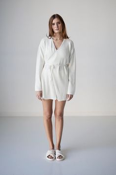 Mini wrap dress in merino wool with tie around waist and subtle bell sleeve. Elegant Dresses With Tie Waist For Loungewear, Fall Wrap Dress With Tie Waist For Brunch, Chic Wrap Robe For Fall, Chic Fall Wrap Robe, Chic Wrap Robe With Tie Waist, Wrap Robe With Tie Waist, Fall Daywear Wrap Dress, Linen Wrap Dress With Tie Waist, Chic Robe With Tie Waist For Loungewear