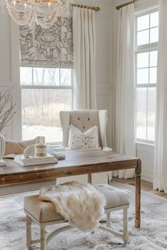 a living room filled with furniture and a chandelier above a wooden dining table