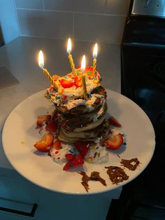 a birthday cake sitting on top of a white plate