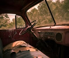 the interior of an old, run down truck with rust on it's dashboard