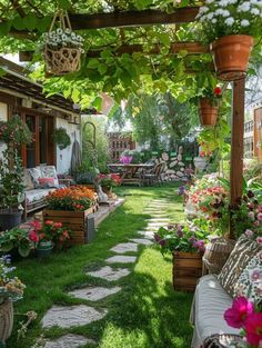 a garden with lots of flowers and plants on the grass under a pergolated trellis