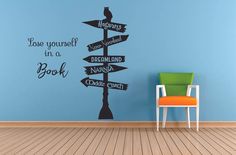 a room with a chair and a wall sticker that says, see yourself in a book