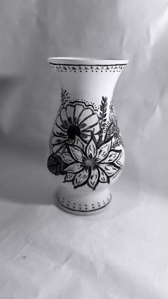 a black and white photo of a vase with floral designs on it's sides