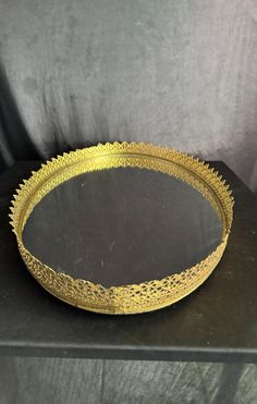 a gold plate sitting on top of a black table