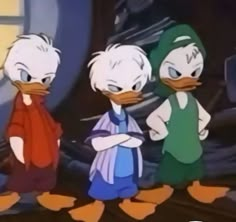 three cartoon ducks standing next to each other in front of a building and looking at the camera