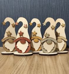 five wooden christmas ornaments are lined up on top of each other, with stars in the background