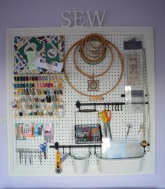 there is a pegboard with many items on it and the word sew above it