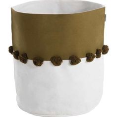 a white and brown hat with pom - poms on it