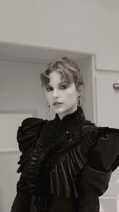 black and white photograph of a woman wearing a dress with ruffles on it