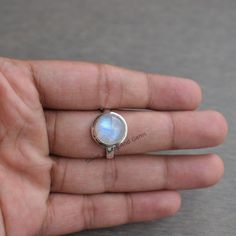 Gemstone-Rainbow Moonstone Shape-Round Stone Size - 10 MM Metal-925 Sterling Silver This One of a kind ring is adorned with beautiful rich Rainbow Moonstone Gemstone set in sterling silver band. About gemstone- Rainbow moonstone is associated with various Moon Goddesses .Moonstone has a very strong connection to the spiritual world. It has great nurturing energy which will give ease and guide in difficult times especially in issues related to love and family. It helps in banishing our own negati Moonstone Rings With Bezel Setting, Sterling Silver Stackable Rings With Natural Stones, Silver Opal Ring For Healing, Natural Stone Stackable Rings, White Moonstone Ring With Bezel Setting, Sterling Silver Round Moonstone Ring With Moon Phase, Silver Stackable Rings With Natural Stones, Moonstone Anniversary Ring, Round Moonstone Ring For Anniversary