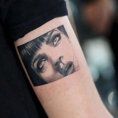 a woman's face is shown on the arm