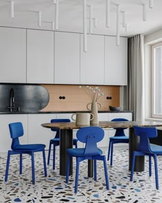 a dining room with blue chairs and a table