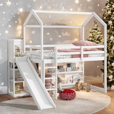 a white bunk bed with a slide in front of it and snowflakes on the wall