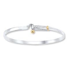 This modern sterling silver bangle bracelet is a lovely addition to her attire. Accents of 14K yellow gold complete the look. The bracelet secures with a hook and eye clasp. Elegant Sterling Silver Bangle Bracelet With Lobster Clasp, Modern Gold Bracelets With Sterling Silver Clasp, Elegant Sterling Silver Bangle With Lobster Clasp, Elegant Adjustable Bangle With Sterling Silver Clasp, Elegant Bangle Bracelet With Spring Ring Clasp, Elegant Bangle Bracelet With Clasp, Modern Sterling Silver Clasp Bracelets For Anniversary, Modern Sterling Silver Clasp Bracelet For Anniversary, White Gold Bangle With Sterling Silver Clasp For Anniversary