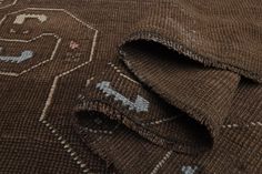 a close up view of a brown rug with animals on it