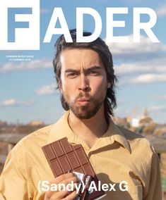 a man holding a chocolate bar on the cover of fader magazine