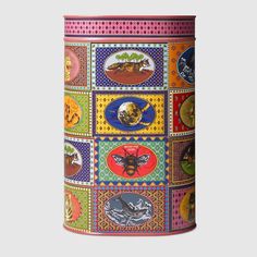 a multicolored canister with different pictures on it's sides and bottom